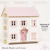 Sophie's Wooden Dolls House is shown in pastel pink with opening and closing windows, shutters, and door. Text reads "Opening & Closing Windows, Shutters & Door" and "Hand Made with Love." A charming toy for creative play.