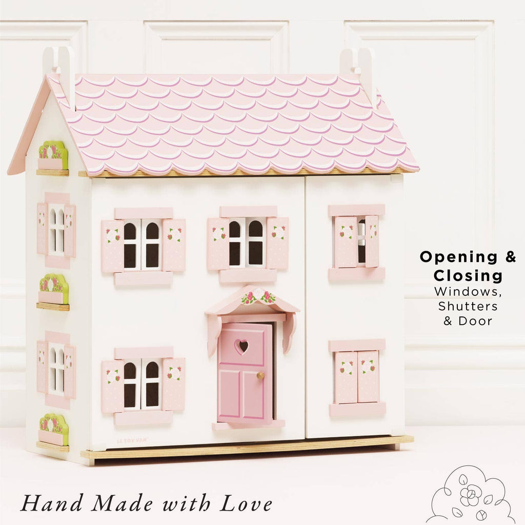 Sophie's Wooden Dolls House is shown in pastel pink with opening and closing windows, shutters, and door. Text reads "Opening & Closing Windows, Shutters & Door" and "Hand Made with Love." A charming toy for creative play.