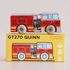 A wooden fire engine labeled “Engine Co. 6” sits atop a yellow box marked “No. 44 GT270 Quinn | Made in England,” featuring illustrations that match the toy inside. Designed for ages 2 and up, this charming toy is perfect for imaginative adventures and heroic rescue missions.