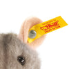 Close-up of the Steiff Piff Mouse Plush Toy, 4 Inches, showing a plush ear with a yellow "Handmade by Steiff KNOPF IM OHR" tag and metal button. Features soft gray fur and a shiny black eye.