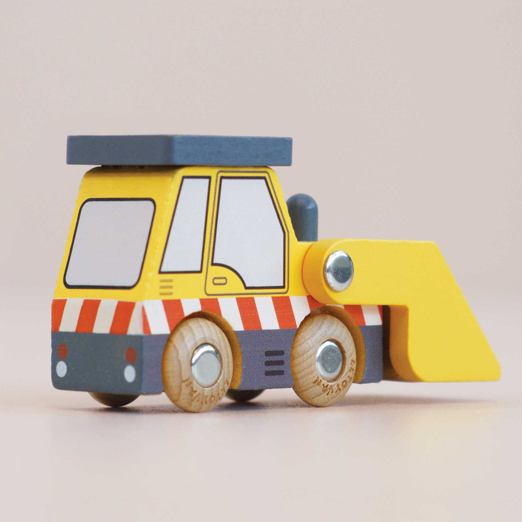 The No. 38 GT220 Vince | Made in England is a small wooden front loader toy, ideal for construction play. It features yellow and gray colors with red and white stripes, four wooden wheels, and is set against a plain, light-colored background that invites imaginative play.