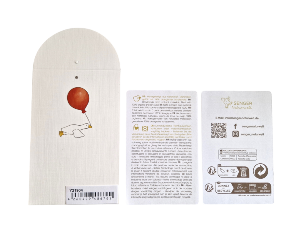 Three product tags: one with a barcode and an illustration of a goose holding a red balloon, another with German text, and the third highlighting Senger Naturwelt Stuffed Animal - Brown Bear, made from GOTS-certified sustainable materials.