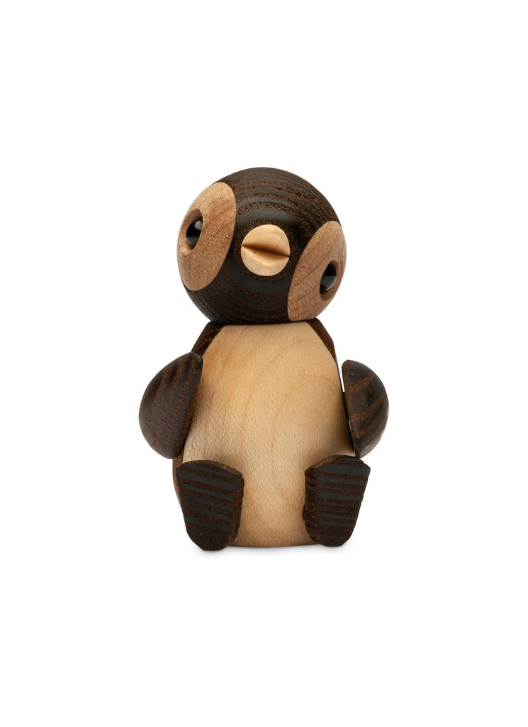 A Spring Copenhagen Snow handmade wooden toy figure resembling a cartoon-style penguin with large eyes and rounded body, displayed against a white background.
