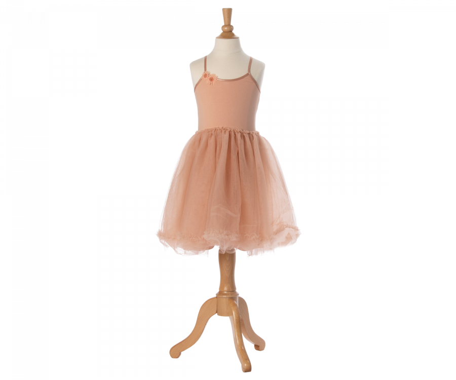 A Maileg Princess Tulle Dress - Melon displayed on a wooden mannequin stand. The sleeveless dress features a soft bodice with a small flower detail on the left strap and a fluffy, tutu-style tulle skirt, fitting perfectly into any magical wardrobe, evoking fairytale dreams.