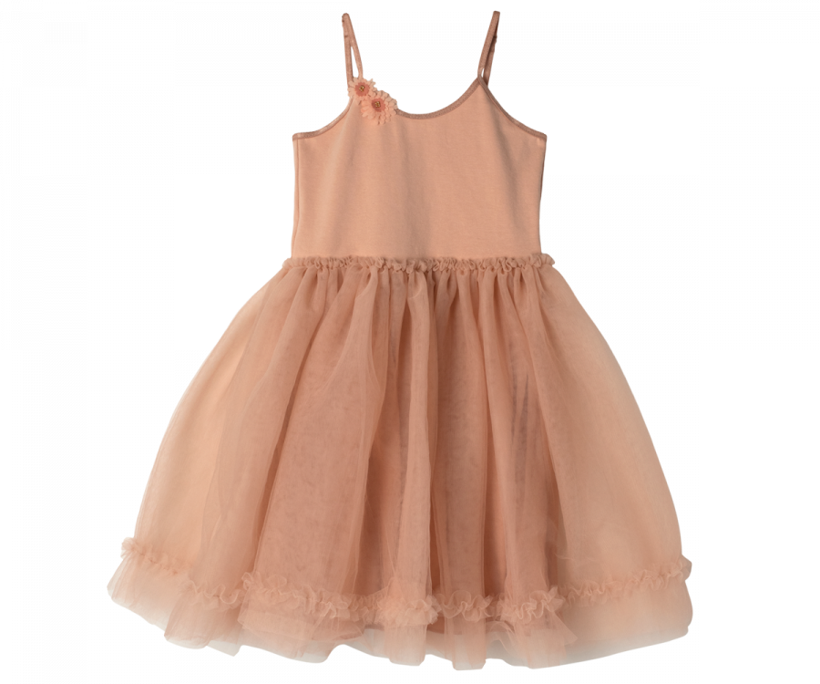 A Maileg Princess Tulle Dress - Melon with thin spaghetti straps, a fitted bodice, and a frilly tulle skirt. The dress has a flower embellishment on the left strap and ruffled detailing at the hem, crafted from soft materials. Perfect for your Magical Wardrobe, it exudes a fairytale dream elegance.