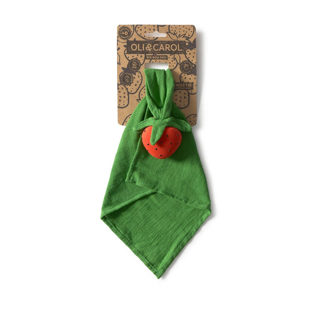 Sweetie the Strawberry Big Doudou is a green organic cotton baby comfort toy featuring a red strawberry-shaped natural rubber teether, presented on brown packaging labeled "Oli & Carol.