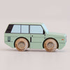 No. 28 GT155 Rory, made in England, is a mint green wooden toy car inspired by classic British design. Shown in profile against a plain light background, it features black windows and detailing, natural wood wheels engraved with “LETOYAN,” and brings an adventurous spirit to playtime.