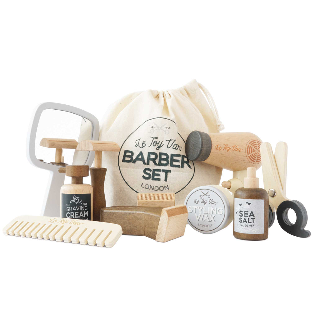 The Wooden Hairdresser & Barber Kit (ships in one week) includes a comb, razor, shaving cream, styling wax, sea salt spray, scissors, brush, mirror & a “Le Toy Van Barber Set London” bag—a charming plastic-free set for imaginative play.