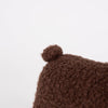 Close-up of Pull-Along Raoul, a brown, textured, fuzzy plush toy with a small round nub on top, set against a plain white background.