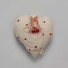 A Coral & Tusk Fox Heart Pocket Valentine decorated with an embroidered illustration of an orange cat holding a bunch of flowers, surrounded by small red heart appliqués, on a gray background.