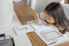 A young girl uses a water-filled pen to color a page in a Winnie-the-Pooh: Pooh’s Birthday Surprise (Water Reveal) book.