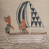 The Sailing Foxes Pillow features embroidery of two foxes on a sailboat with striped and geometric sails, one using a telescope and the other steering. This charming design is ideal for decor, stitched on a light fabric background.