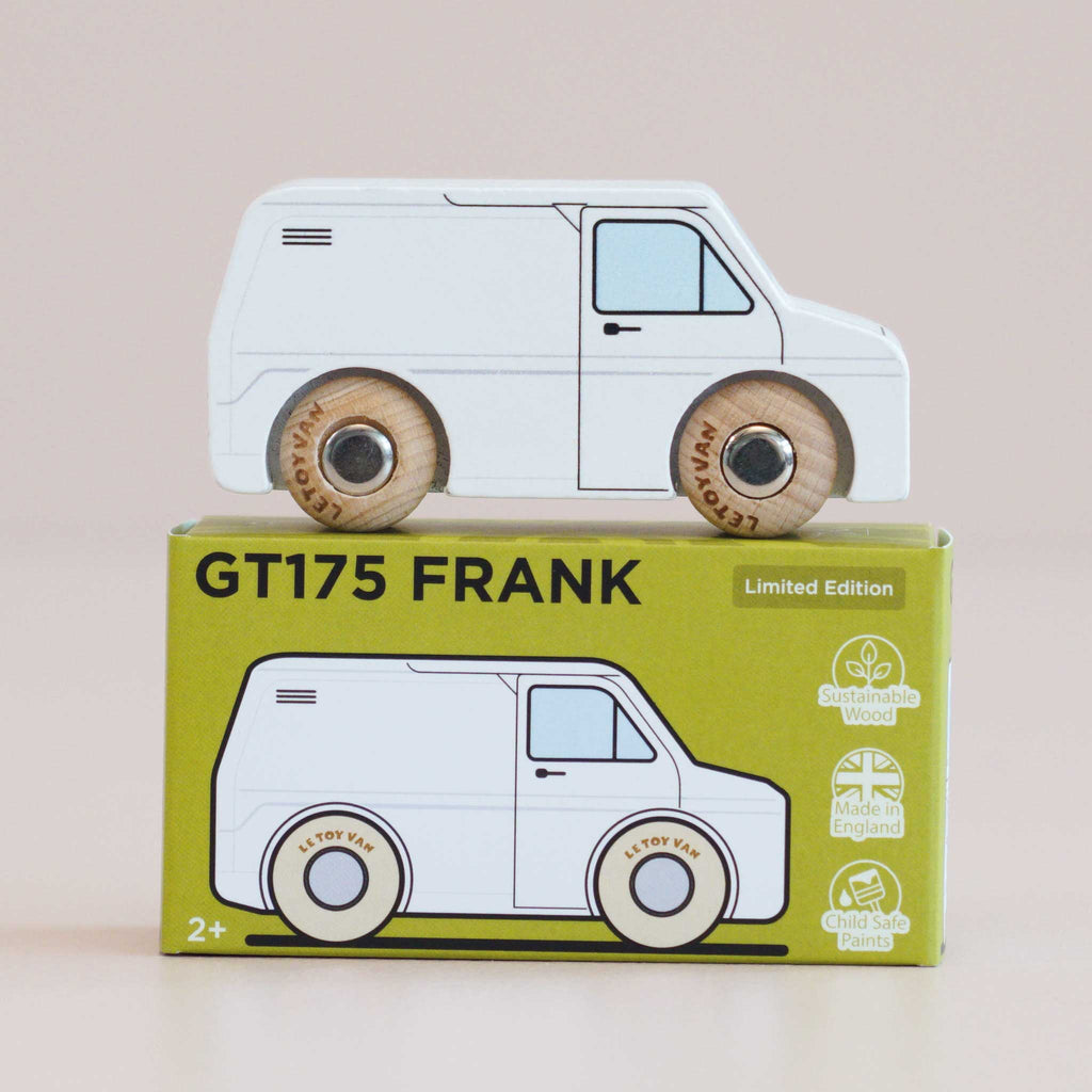 A classic wooden toy, the No. 32 GT175 Frank white van is crafted in England with sturdy wooden wheels and comes atop a green box labeled “GT175 FRANK.” The packaging features eco-friendly icons and a delightful illustration of the van, making it perfect for imaginative play. Suitable for ages 2 and up.
