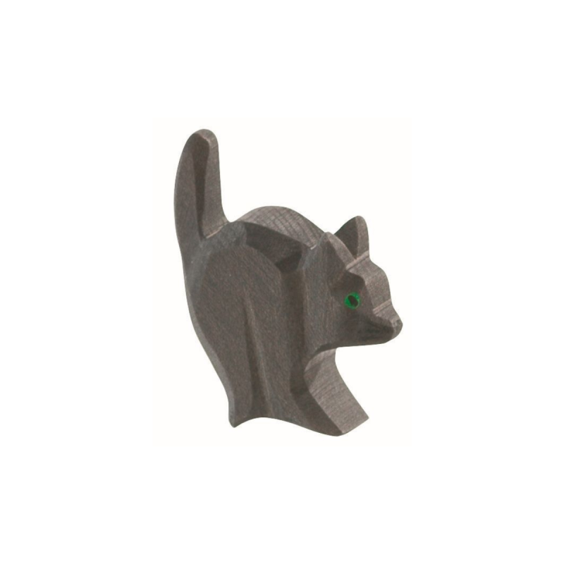 The Ostheimer Cat For Witch is a small, wooden figurine carved in a playful, standing pose with its tail raised. Handcrafted from sustainable materials, this cat features a simplistic design with minimal detailing and is painted in a dark brown color. Bright green accents mark the eyes, capturing the charming style reminiscent of Ostheimer toys.