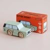 A mint green wooden 4x4 toy car sits in front of its orange box, labeled “No. 28 GT155 Rory | Made in England” and “Limited Edition.” Highlighting classic British design, the box features illustrations matching the adventure toy and displays eco-friendly icons.