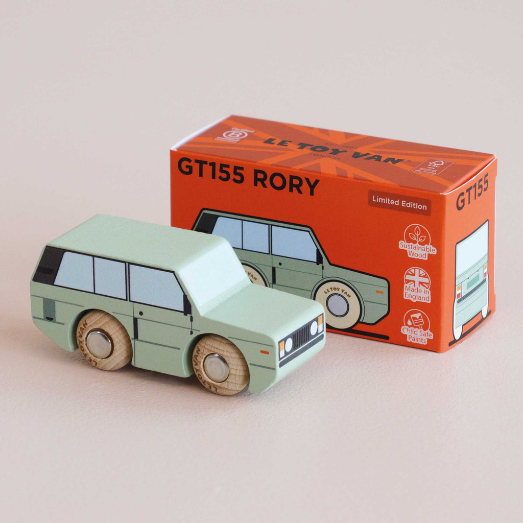 A mint green wooden 4x4 toy car sits in front of its orange box, labeled “No. 28 GT155 Rory | Made in England” and “Limited Edition.” Highlighting classic British design, the box features illustrations matching the adventure toy and displays eco-friendly icons.
