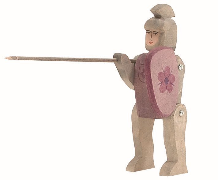 Introducing the Ostheimer Red Knight - Riding, a handcrafted wooden figurine of a medieval knight. This charming toy features the knight holding a long spear in its right hand and a pink shield adorned with a floral design in its left. With simplistic facial features and a helmet sporting a top crest, this figurine is reminiscent of classic Ostheimer toys. Perfect for imaginative play, it even boasts movable joints for dynamic posing and adventures.