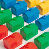 A grid of Monopoly Junior Vintage Bookshelf Edition plastic toy houses in red, green, blue, and yellow arranged on a white surface.