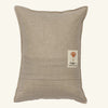 A rectangular beige linen pillow with a small embroidered orange coral patch and "CORAL & TUSK" text—perfect Easter decor or for pairing with the Coral & Tusk Sugar Egg Pocket Pillow.