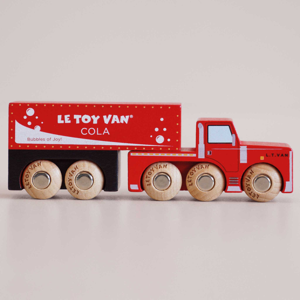 A red wooden toy truck labeled “No. 33 GT180 Toby | Made in England” with six wheels and white decorative bubbles, this wooden cola truck features a charming vintage-inspired design, perfect for imaginative storytelling and pretend play as a classic cola delivery vehicle.