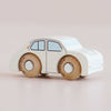 The No. 20 GT110 Rene, made in England, is a small white wooden toy car featuring simple blue windows and brown wheels; photographed on a light background, this classic toy inspires imaginative play for children of all ages.