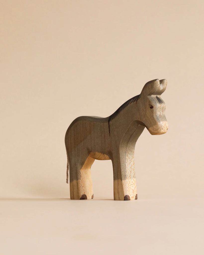 A stylized, handmade wooden toy donkey from the Handmade Holzwald Shepherd & Farm Animals Set.