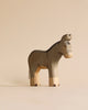 A minimalist, sustainable Handmade Holzwald Donkey toy with a grey body and lighter natural wood legs.