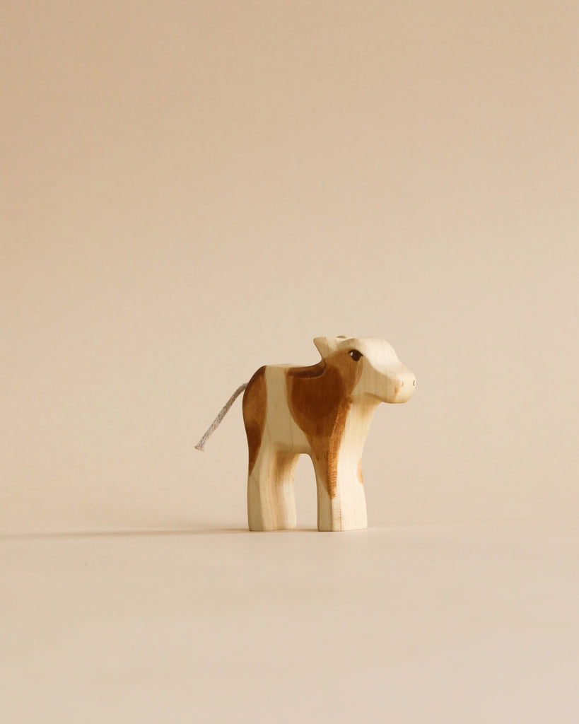 The Handmade Holzwald Shepherd with Farm Animals Set includes a hand-carved wooden cow with brown and white patches—ideal for those who value sustainable, artisanal toys.