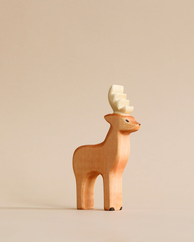 Small handmade wooden figurine of a standing deer with pale antlers from the Handmade Holzwald Woodland Animals Set.
