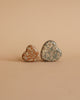 The Maileg LouiMax On the Go Suitcase Set features two heart-shaped cases with floral patterns, one in brown and one in blue, displayed side by side on a light beige background.