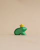 A small, Handmade Holzwald Frog King figurine crafted from sustainable toys, standing against a plain beige background.