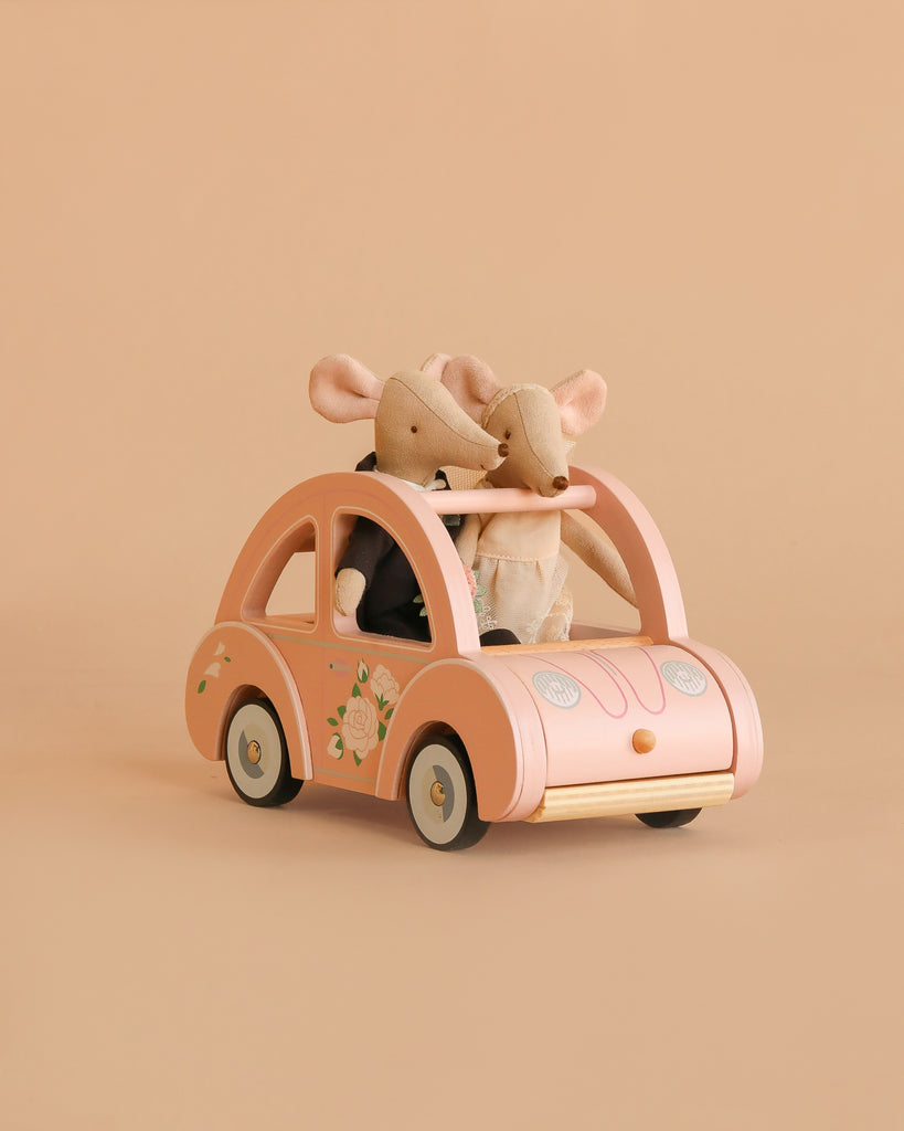 The Maileg Just Married Set features two wedding mice in charming outfits sitting in a pink floral toy car—an ideal addition to Sophie's Dolls House adventures.