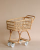 A rattan Grocery Shopping Cart against a plain beige background, featuring a basket atop a sturdy, bamboo-framed wheeled base.