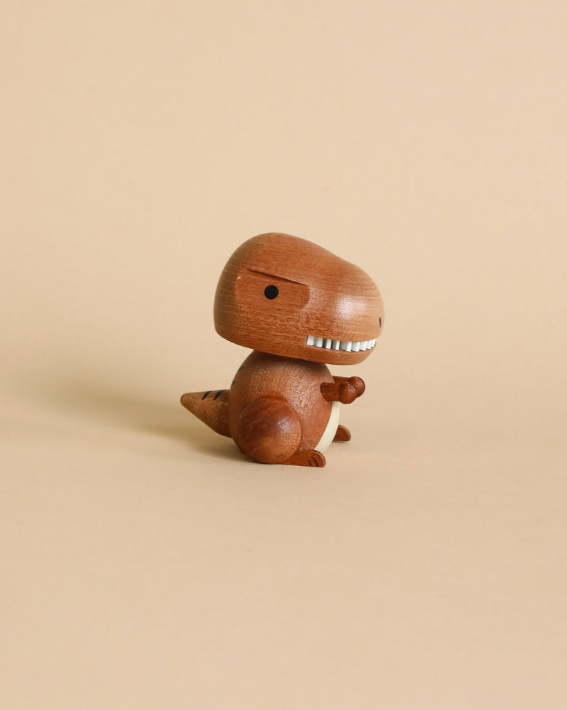A Wooden T-Rex Bobblehead with a simplistic design stands against a plain beige background, featuring a round head, small arms, and a tail.