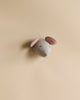 A simple handcrafted Felt Mouse Wall Decor - Mini with a grey body, pink inner ears, and a small tail is pictured against a plain light beige background.