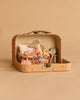 The Maileg On The Go Suitcase Set features a Little Sister Mouse in charming clothes inside an open beige suitcase styled as a cozy room with a chair, table, pillow, and alarm clock—perfect for your Maileg Dollhouse Accessories collection.