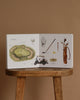 The Sports Storytime Set, displayed open on a wooden stool, features illustrated golf equipment and a course diagram—perfect for introducing preschoolers to first words and sports vocabulary.