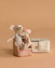 The Maileg Mommy and Me Set features two fabric toy mice seated on a soft pink folding chair beside a small lace-trimmed decorative box, all displayed against a plain beige background.