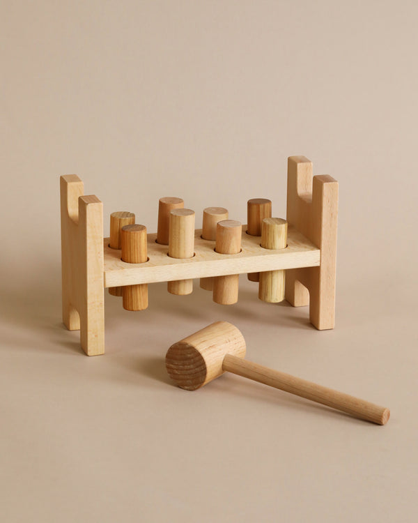 A wooden pounding toy with a wooden hammer.