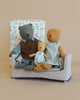 Three Maileg Teddy Family Sets - Gift Wrapped, known affectionately as "Teddy Mum" and her cubs, are sitting together on a miniature Ma.