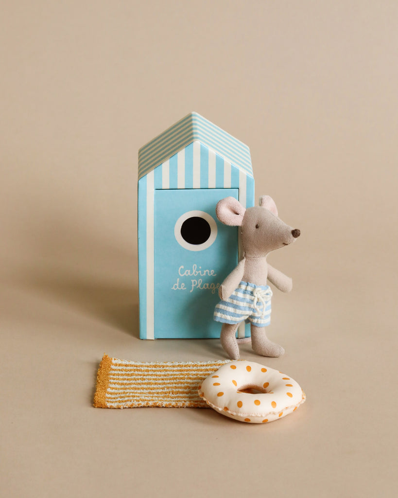 The Maileg Little Brother Gone Fishing Set features a Beach Mouse in blue striped shorts, accompanied by fishing gear and charming accessories perfect for imaginative play.