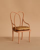 The Maileg Vintage Chair, Mini - Dark Powder is a small, elegant chair with a curved metal back and arms, painted dark powder, and features a cushioned seat—perfect as unique rabbit furniture against a beige background.