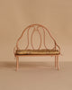 A light pink, small metal bench with a tan floral cushion—ideal for displaying miniature cakes or seating your Maileg Ballet Bunny and Rabbit Set against a simple beige background.