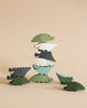 10 wooden stackable crocodile shaped pieces in various shades of green.