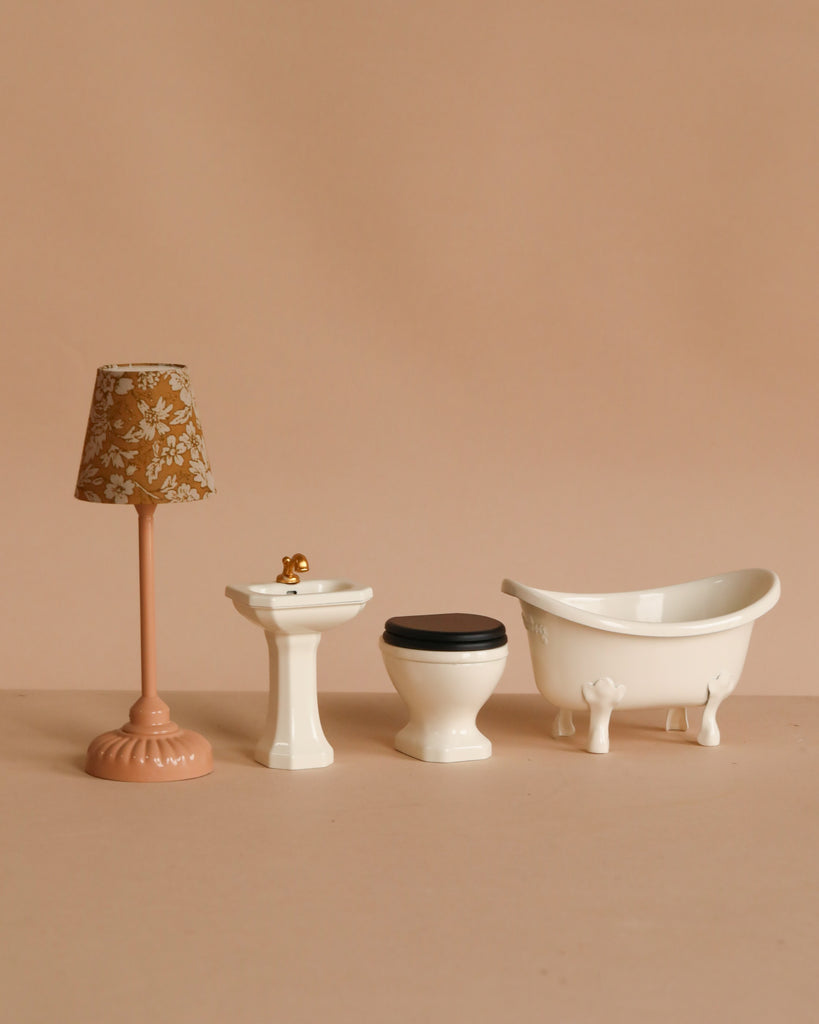 The Maileg Bathroom Sink, Mouse Size - Off White, is a charming mouse house accessory featuring an off white sink with faucet—perfect for adding an elegant touch to your miniature bathroom decor.