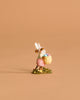 The Wee Forest Folk Tiny Collectible - Hoppy Easter Girl (Not a Toy) features a handmade mouse in a pink dress with bunny ears, holding a basket of pastel eggs on grass—a delightful piece for collectors.