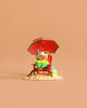 The Wee Forest Folk Tiny Collectible - Perfect Beach Day! features a hand-sculpted mouse in green shorts, relaxing on a red beach chair under a red umbrella, with watermelon and book in hand. A green shoe and blue bag rest nearby. Not a toy.