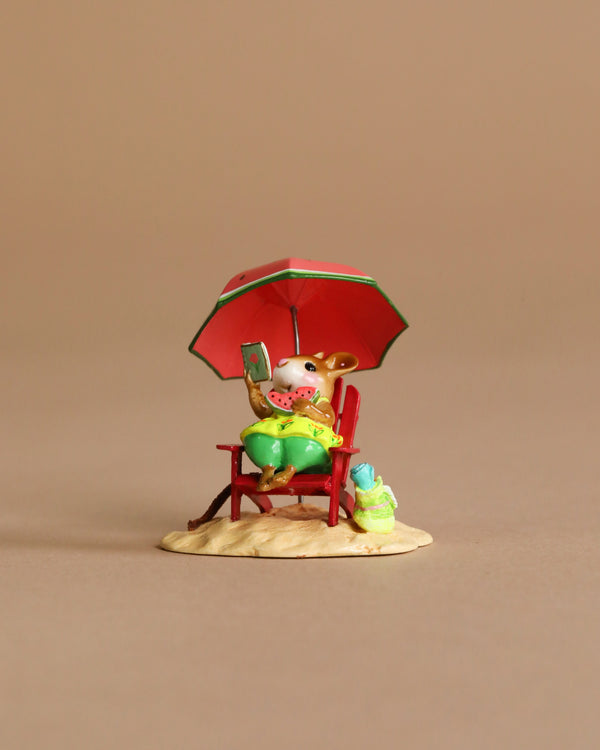 The Wee Forest Folk Tiny Collectible - Perfect Beach Day! features a hand-sculpted mouse in green shorts relaxing on a red chair under a matching umbrella, holding watermelon and a book, with tiny accessories on sandy ground.