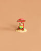 The Wee Forest Folk Tiny Collectible - Perfect Beach Day! (Not a Toy) features a hand sculpted mouse at a table under a red umbrella with a drink and bag on sandy base, set against a plain beige background.