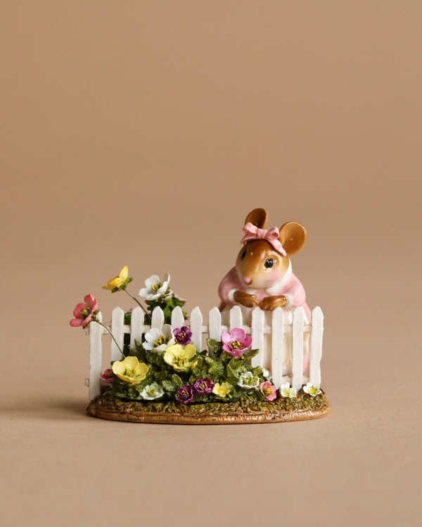 The Wee Forest Folk Tiny Collectible - Annette's Garden features a hand-sculpted mouse in a pink dress and bow, standing behind a white picket fence with colorful flowers, set against a plain beige background. Not a toy.